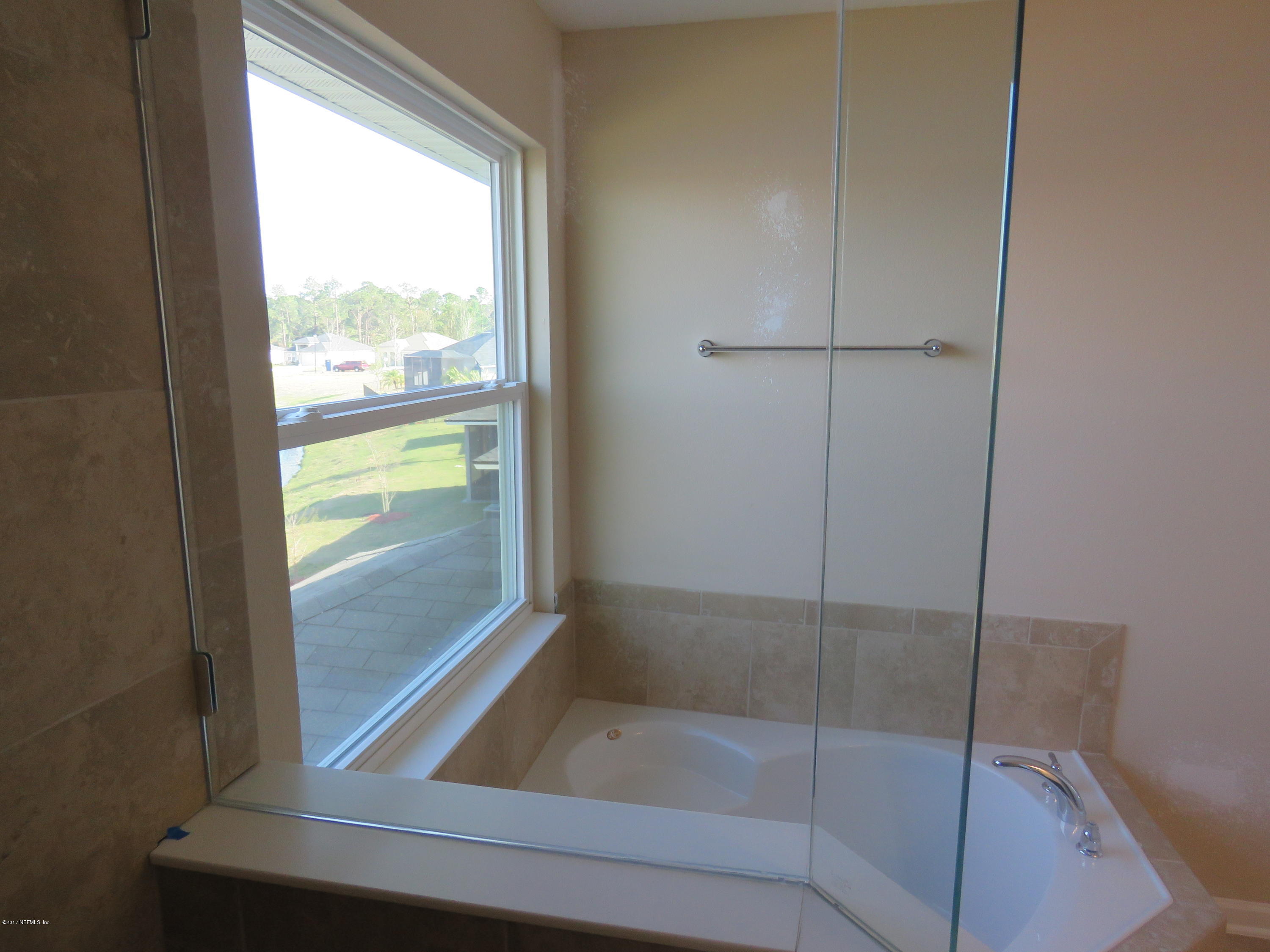 516 Deer Crossing Road St. Augustine, FL 32086 - Photo 40 of 43 a bathroom with a glass shower door