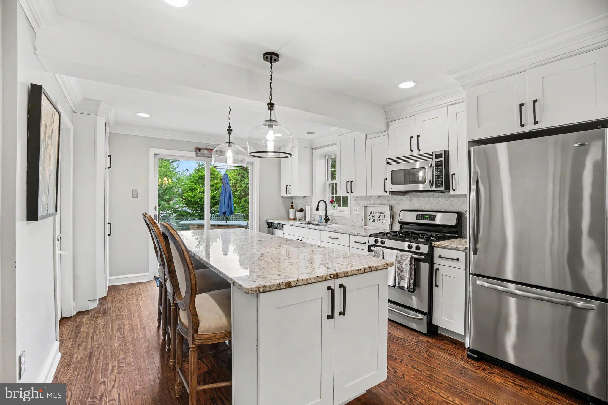 235 Hopkins Road Haddonfield, NJ 08033 - Photo 8 of 47 a kitchen with stainless steel appliances granite countertop a refrigerator a stove a sink a dining table and chairs