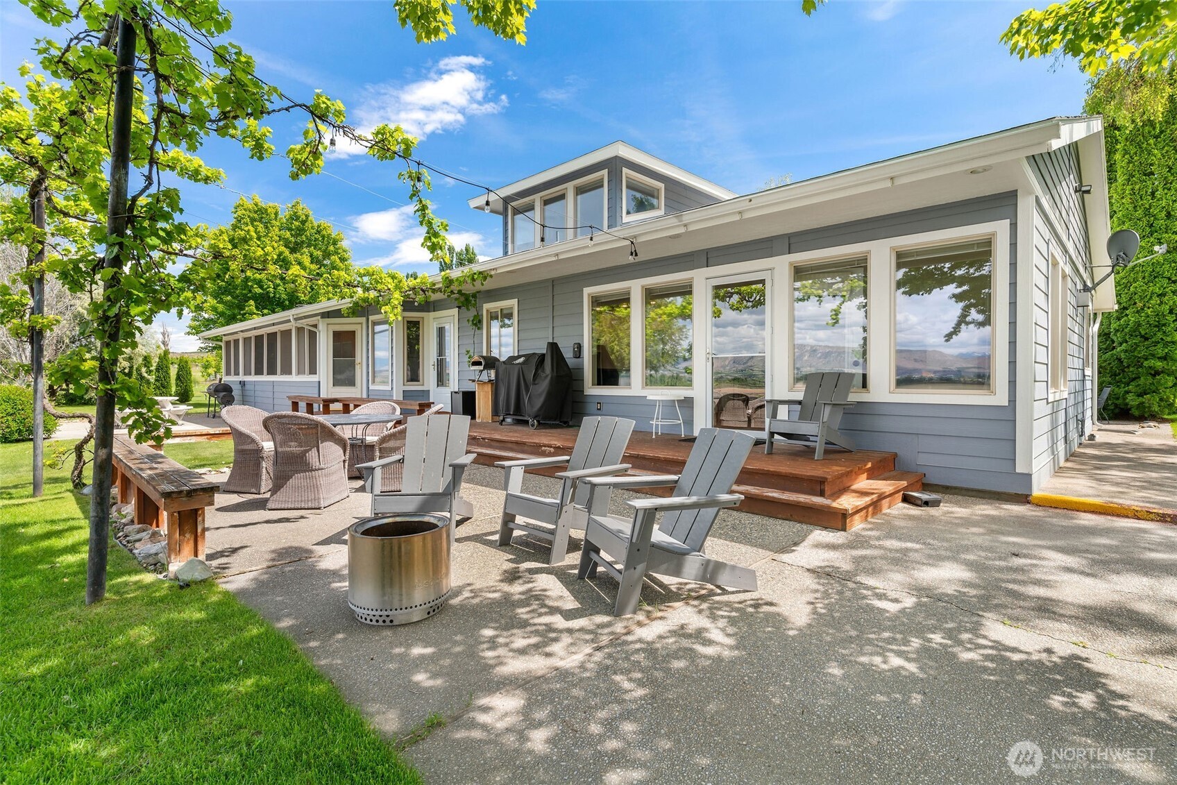 32 Midland Road Brewster, WA 98812 - Photo 5 of 40 a view of a patio with table and chairs potted plants and a large tree