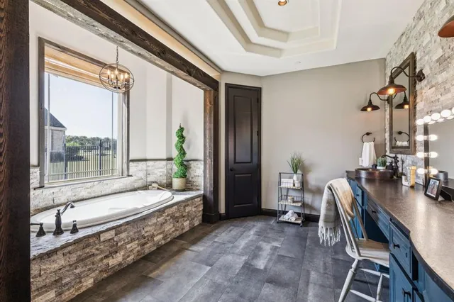 a bedroom with furniture and a large window