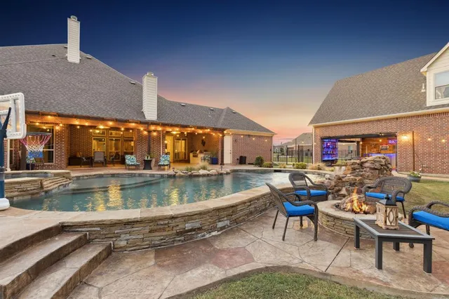 a view of a swimming pool with outdoor seating