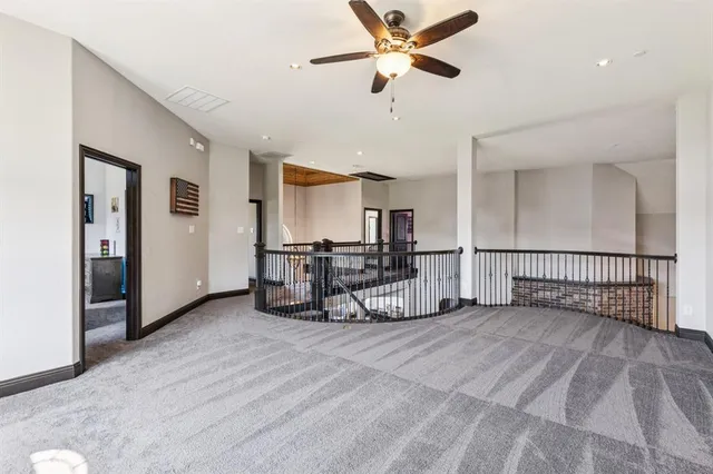 a view of a livingroom with furniture and a ceiling fan