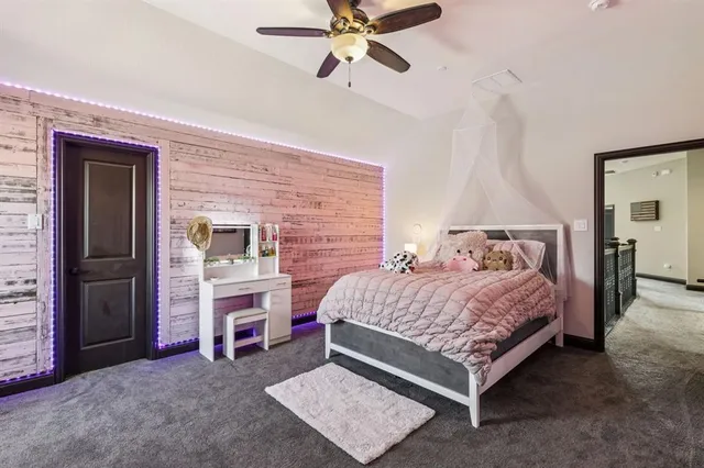 a bedroom with a bed and a ceiling fan