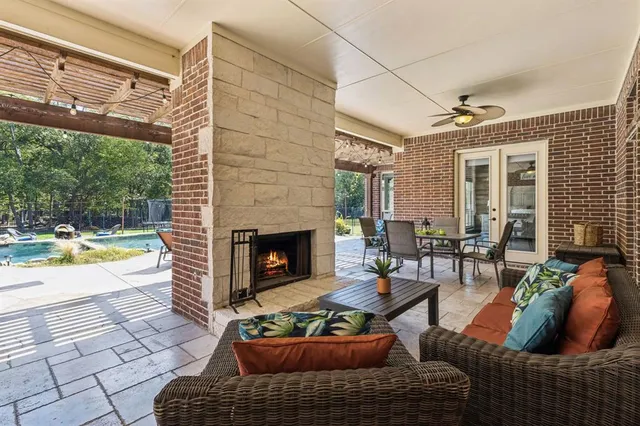 a living room with furniture a fireplace and a floor to ceiling window