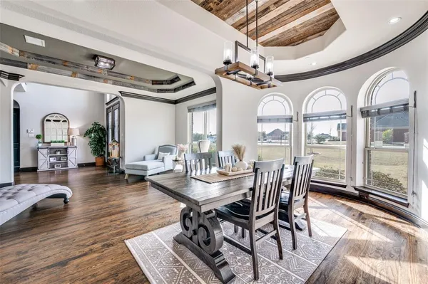 a kitchen with a sink and chairs