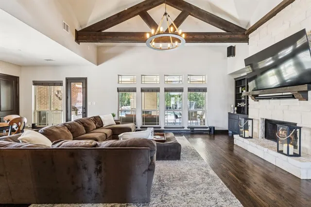 a living room with furniture fireplace and flat screen tv