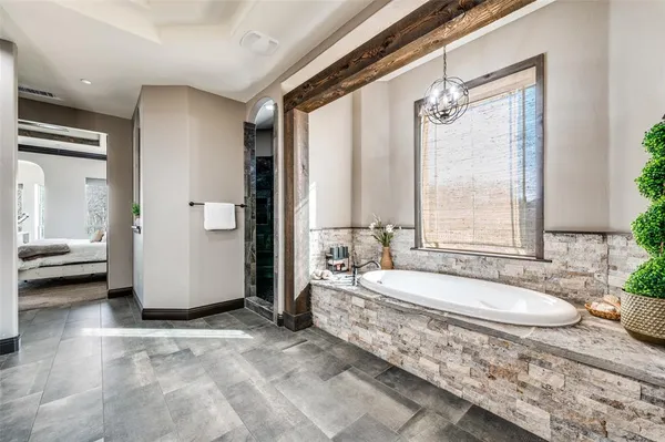a kitchen with stainless steel appliances granite countertop a stove a sink dishwasher a refrigerator and a oven with wooden floor