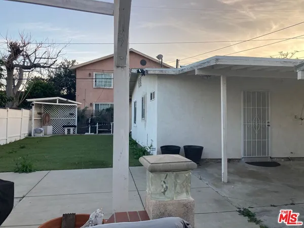 a backyard of a house with table and chairs