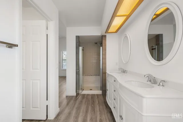a bathroom with a double vanity sink and a mirror
