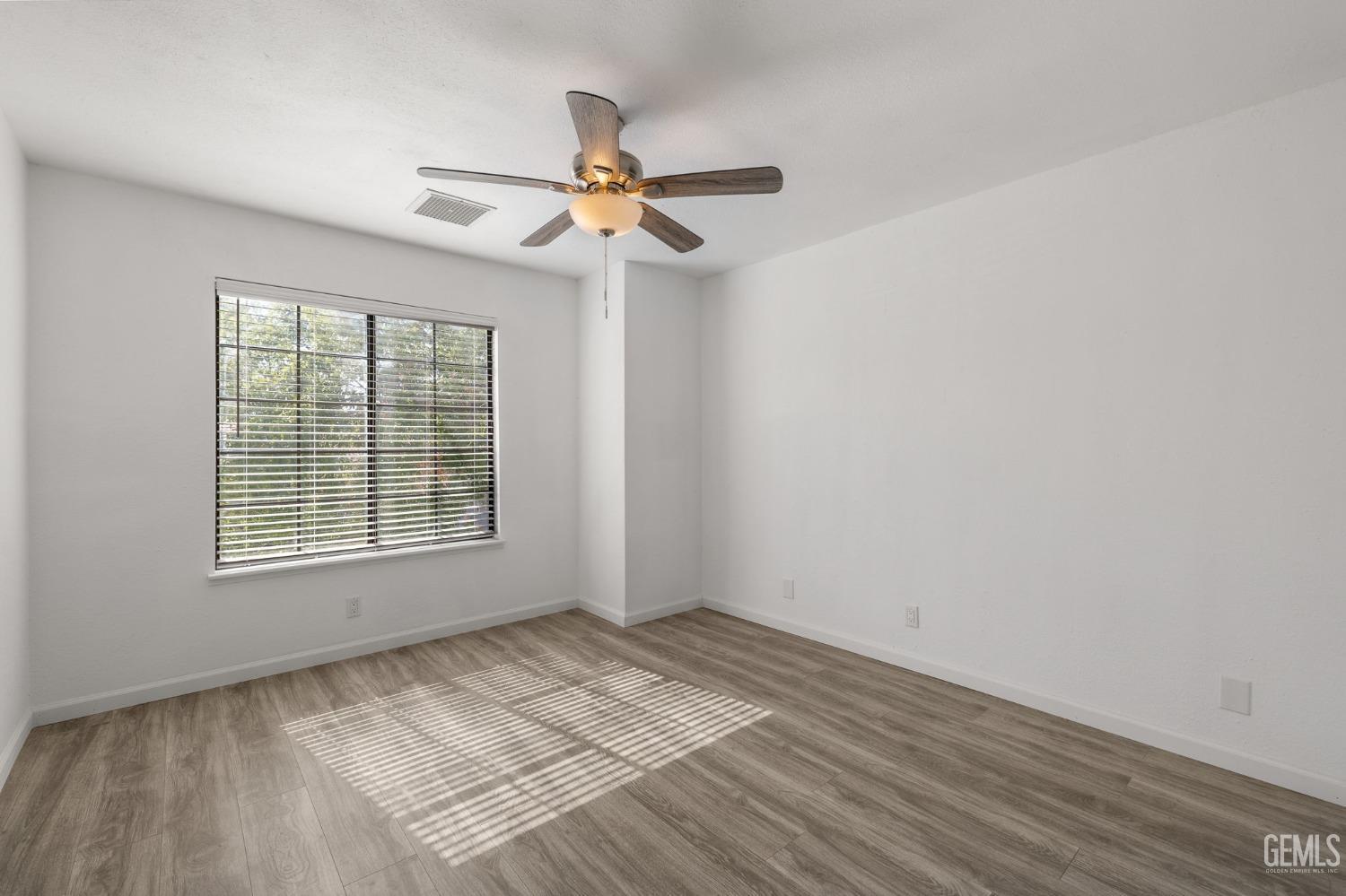Undisclosed Address Ridgecrest, CA 93555 - Photo 22 of 34 an empty room with a window and a fan