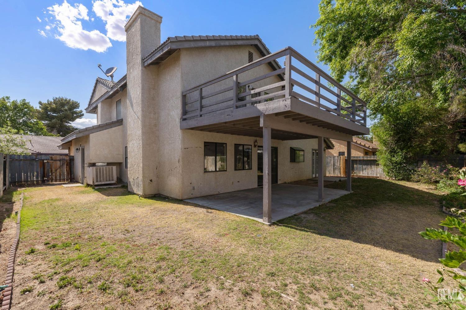 Undisclosed Address Ridgecrest, CA 93555 - Photo 25 of 34 a front view of a house with a yard and garage