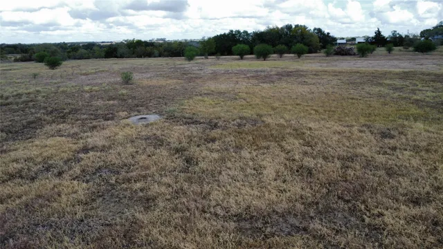 a view of a lake with beach and green space