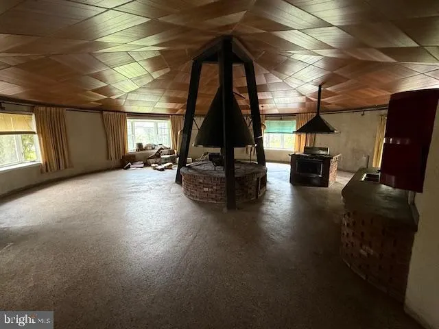 a view of a room with wooden floor and windows