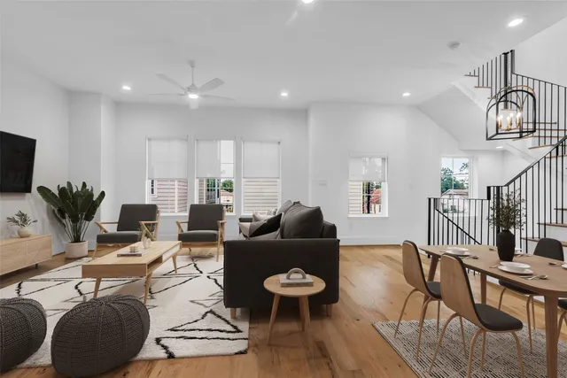 a living room with furniture a rug and a chandelier