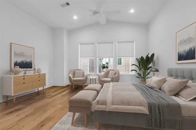 a bedroom with a large bed and a window