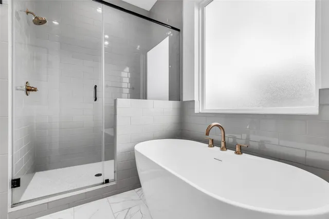 a bathroom with a sink a shower and mirror