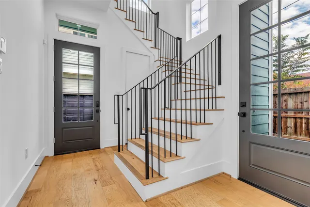 a view of staircase with white walls and windows