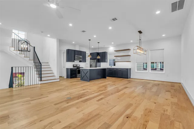 a view of kitchen and hall with wooden floor