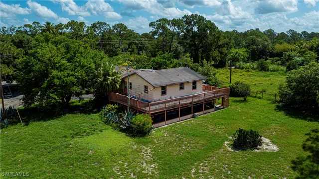 an aerial view of a house with a big yard
