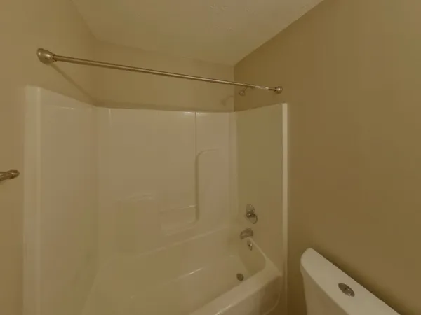 a bathroom with a shower and a bath tub