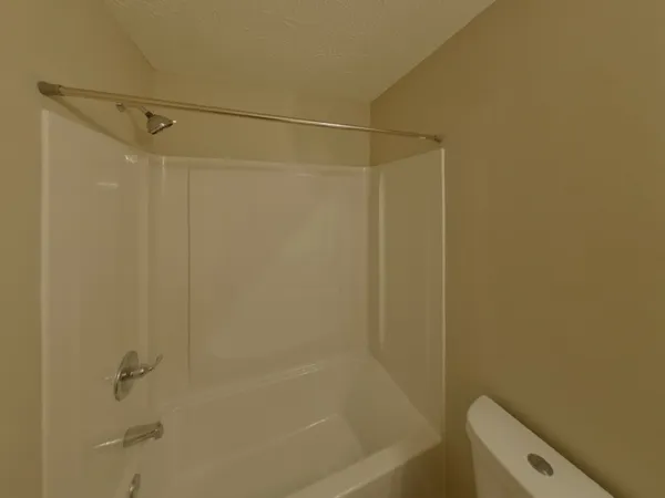 a bathroom with a shower and a toilet