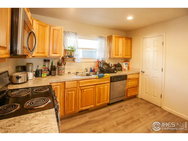 a kitchen with a sink cabinets and window