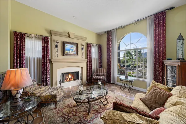 a living room with fireplace furniture and a fireplace