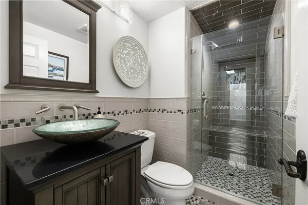 a spacious bathroom with a mirror a bathtub and shower