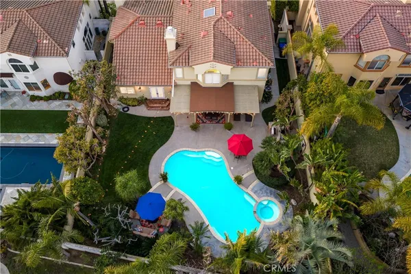 a view of a swimming pool with a patio and a yard