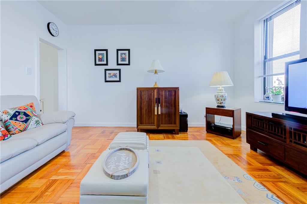255 79th Street, Unit E11 Brooklyn, NY 11209 - Photo 11 of 34 a living room with furniture and a flat screen tv