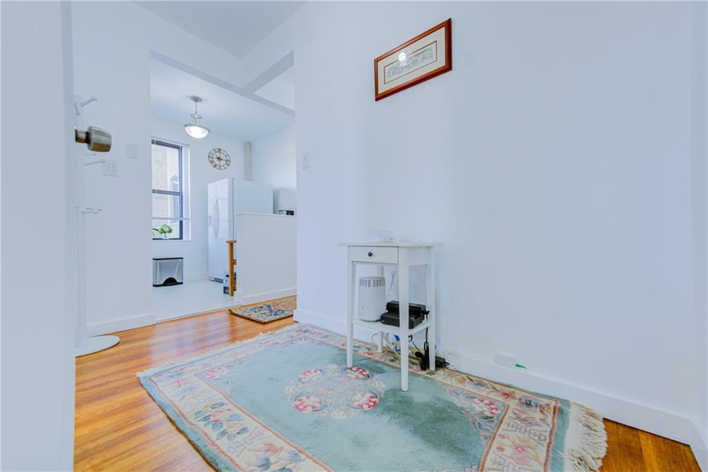 255 79th Street, Unit E11 Brooklyn, NY 11209 - Photo 16 of 34 wooden floor with table and chairs in it