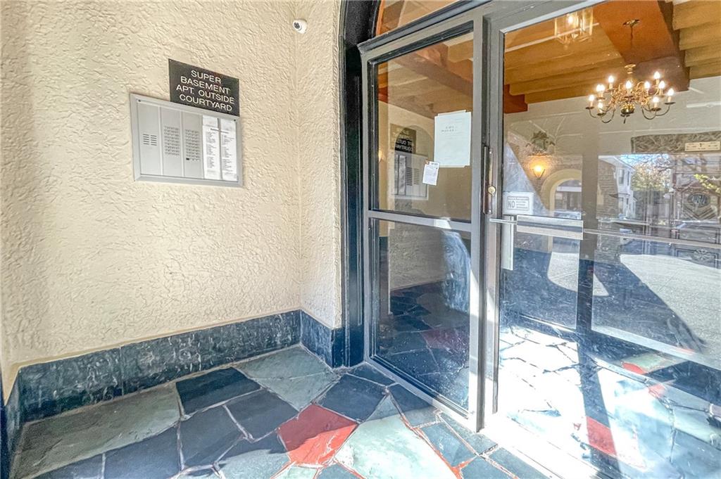 255 79th Street, Unit E11 Brooklyn, NY 11209 - Photo 3 of 34 a room with a glass door shower and fireplace