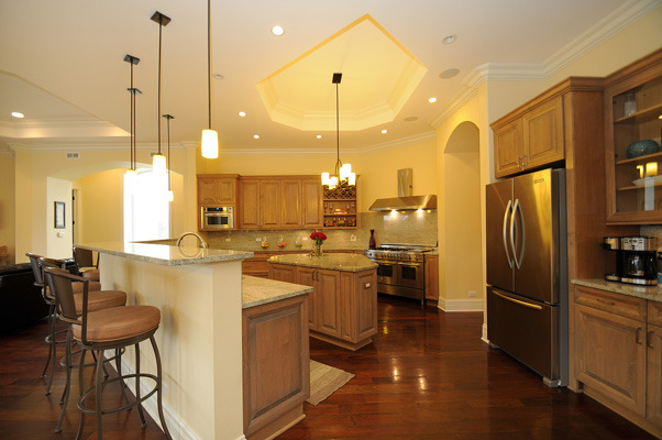 10 Ruffled Feathers Drive Lemont, IL 60439 - Photo 6 of 25 a kitchen with stainless steel appliances granite countertop a refrigerator a sink a stove and a wooden floors