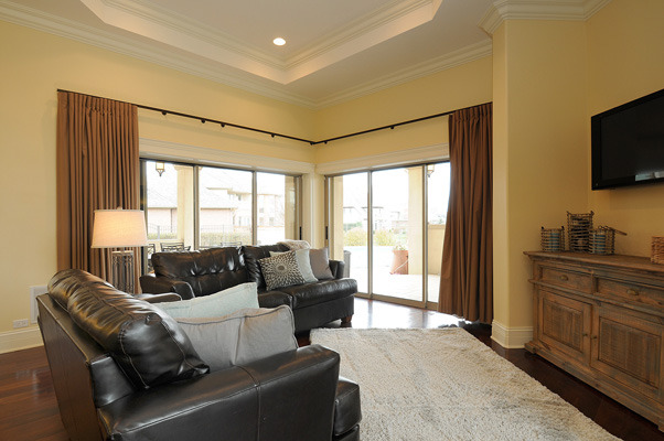 10 Ruffled Feathers Drive Lemont, IL 60439 - Photo 9 of 25 a living room with furniture and a flat screen tv