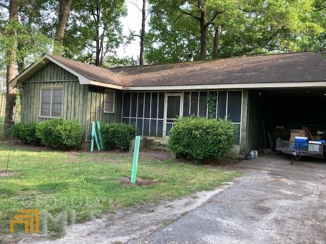 436 Country Club Road Dublin, GA 31021 - Photo 1 of 1 a view of a house with a yard plants and a large tree