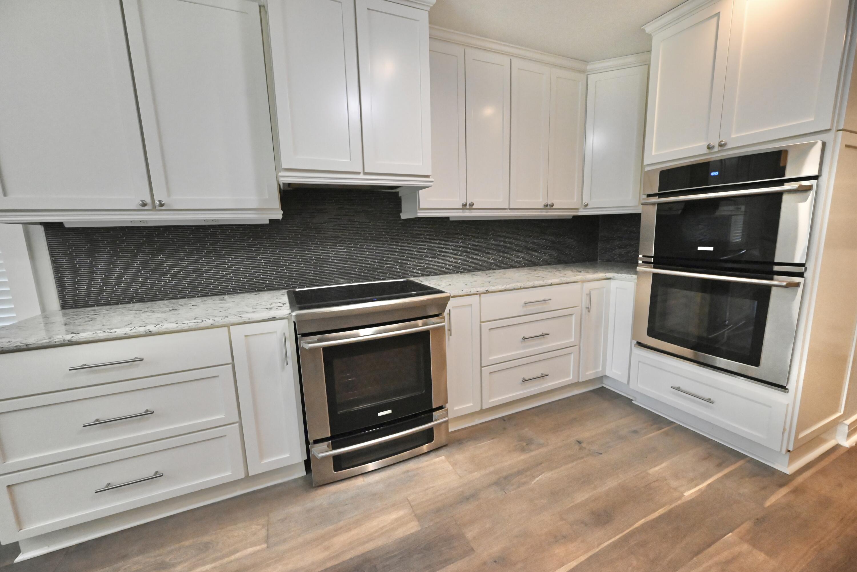 202 Shell Drive Crestview, FL 32536 - Photo 11 of 38 a kitchen with white cabinets and appliances