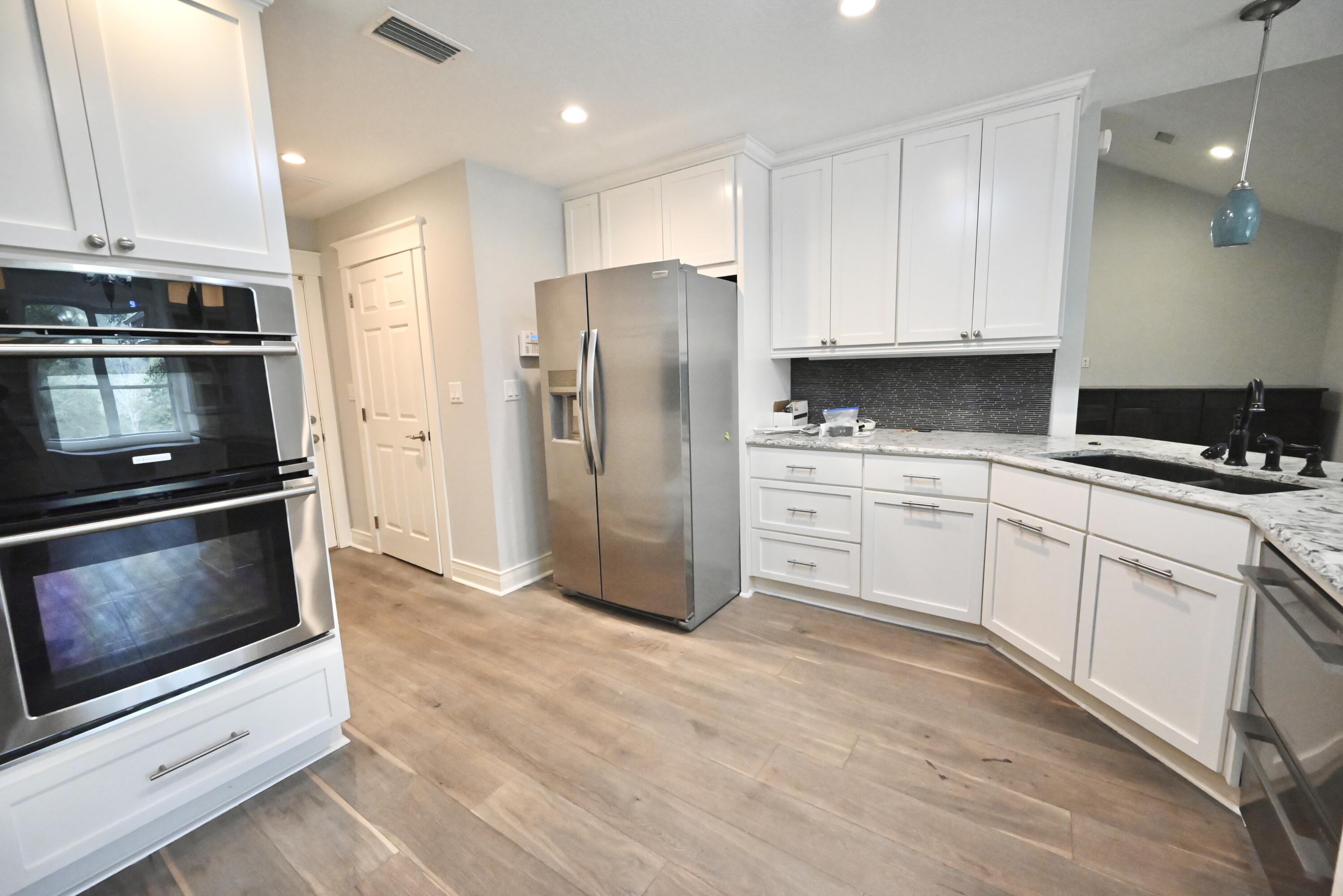 202 Shell Drive Crestview, FL 32536 - Photo 12 of 38 a kitchen with stainless steel appliances a stove a microwave and a sink