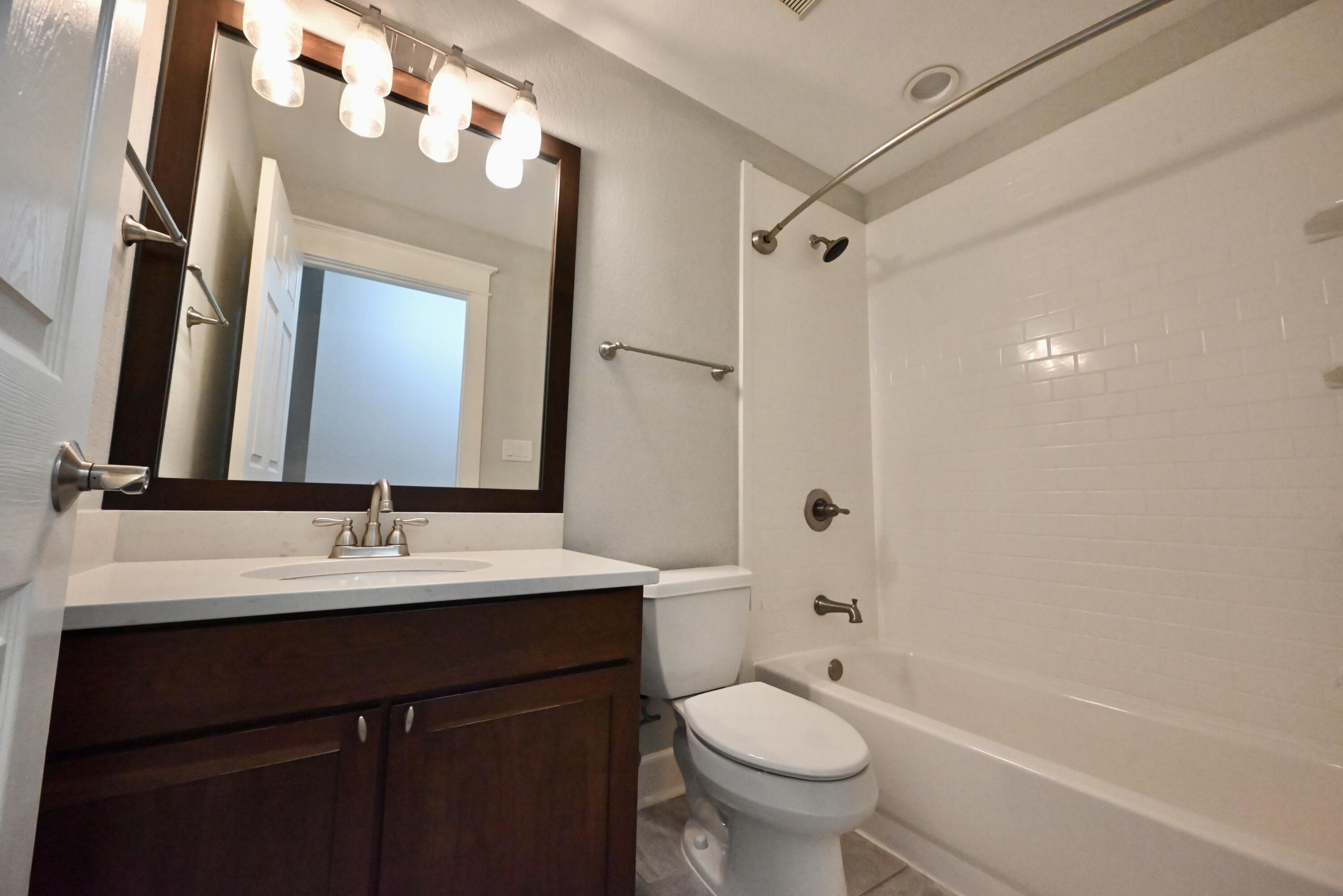 202 Shell Drive Crestview, FL 32536 - Photo 19 of 38 a bathroom with a sink a toilet and shower a mirror