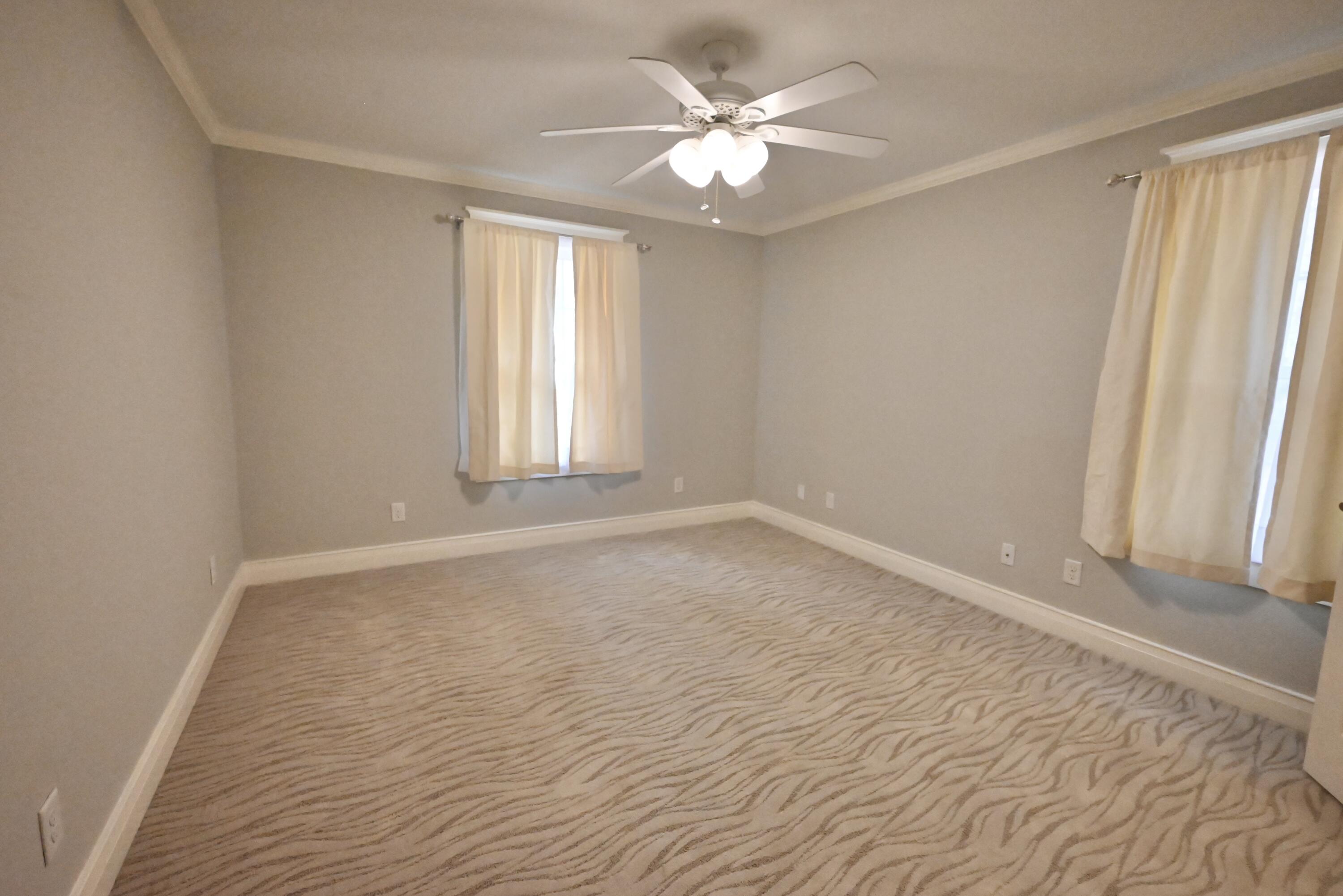 202 Shell Drive Crestview, FL 32536 - Photo 20 of 38 wooden floor in an empty room with a window
