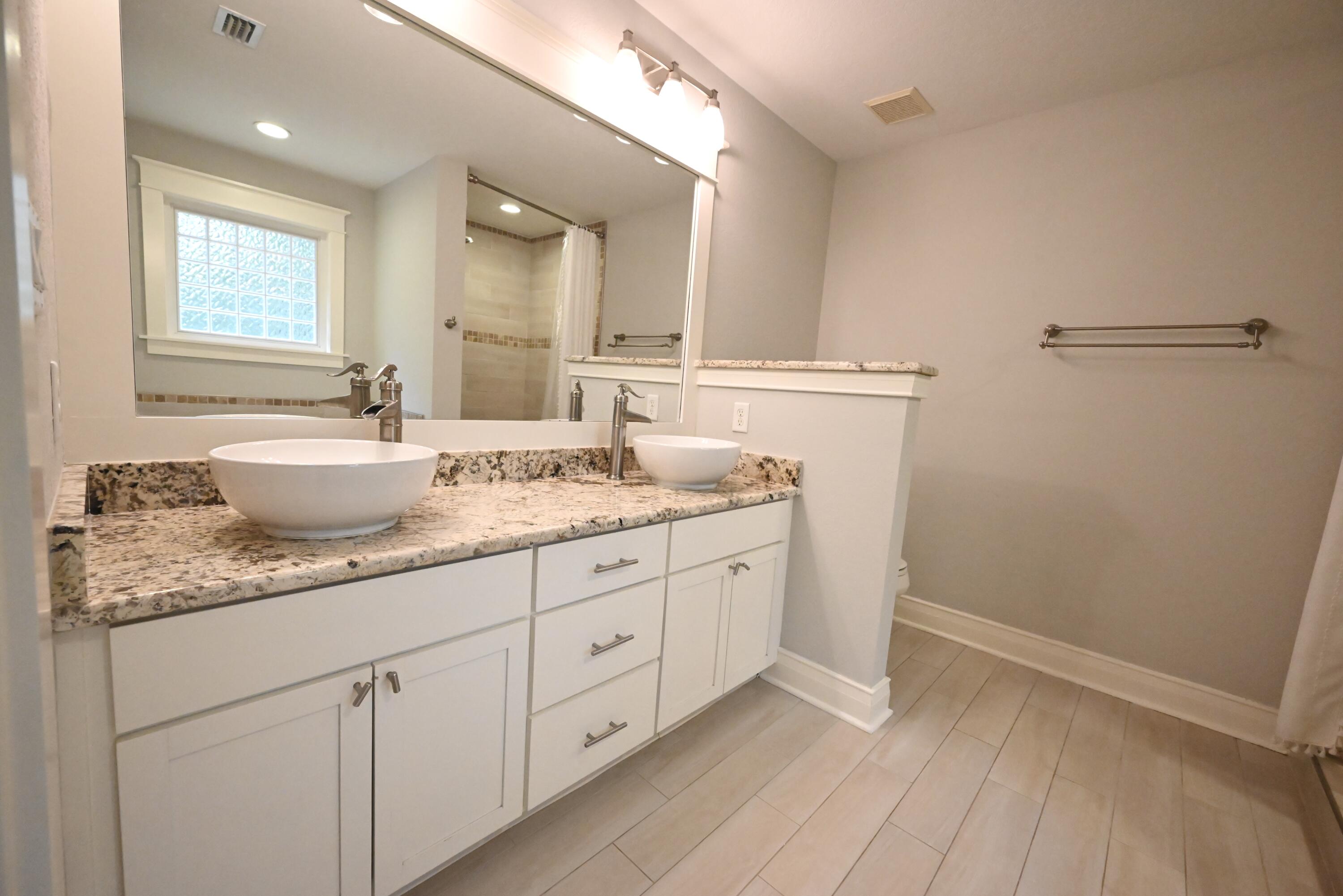 202 Shell Drive Crestview, FL 32536 - Photo 27 of 38 a bathroom with a granite countertop sink mirror and toilet