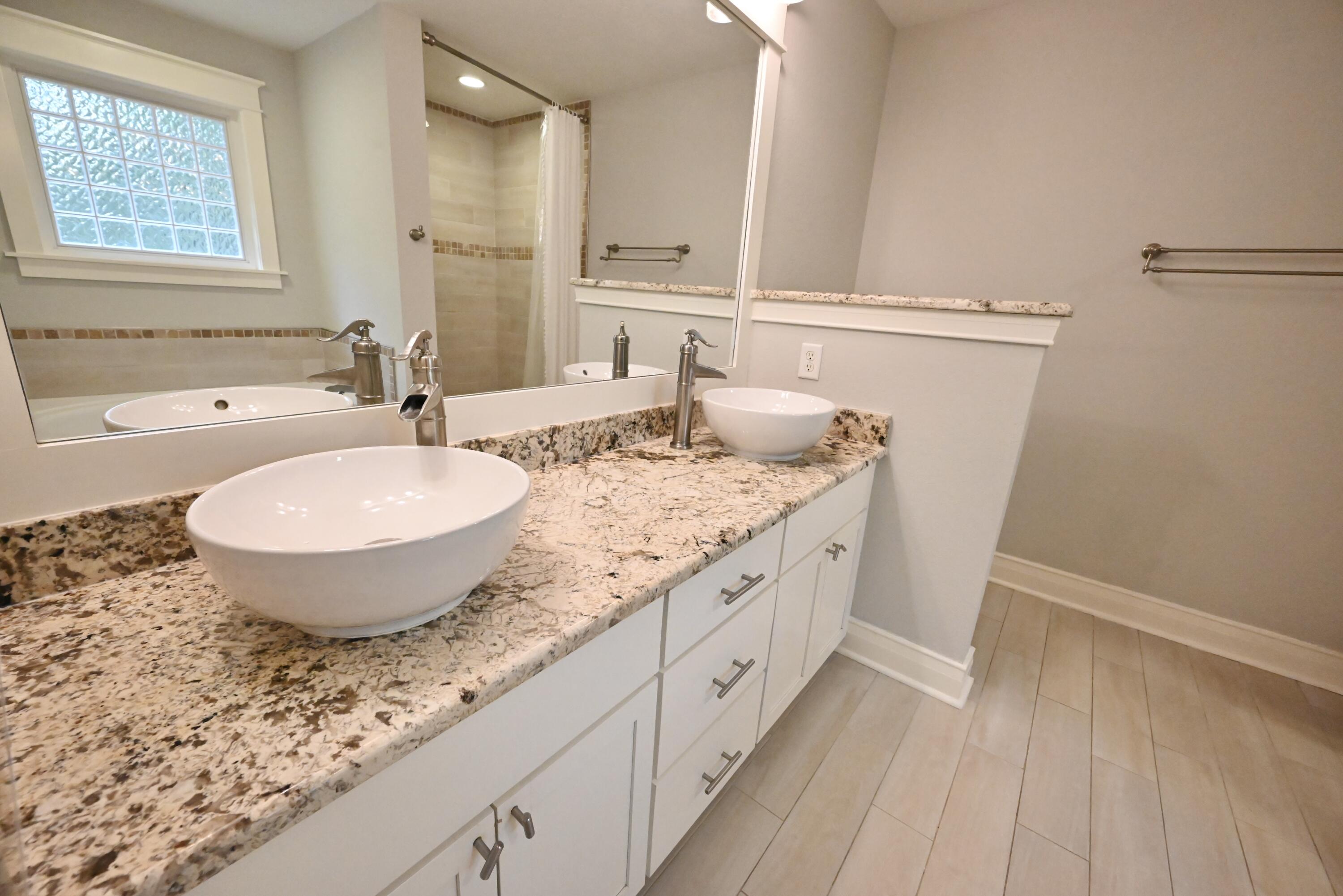 202 Shell Drive Crestview, FL 32536 - Photo 29 of 38 a spacious bathroom with a granite countertop sink and a mirror