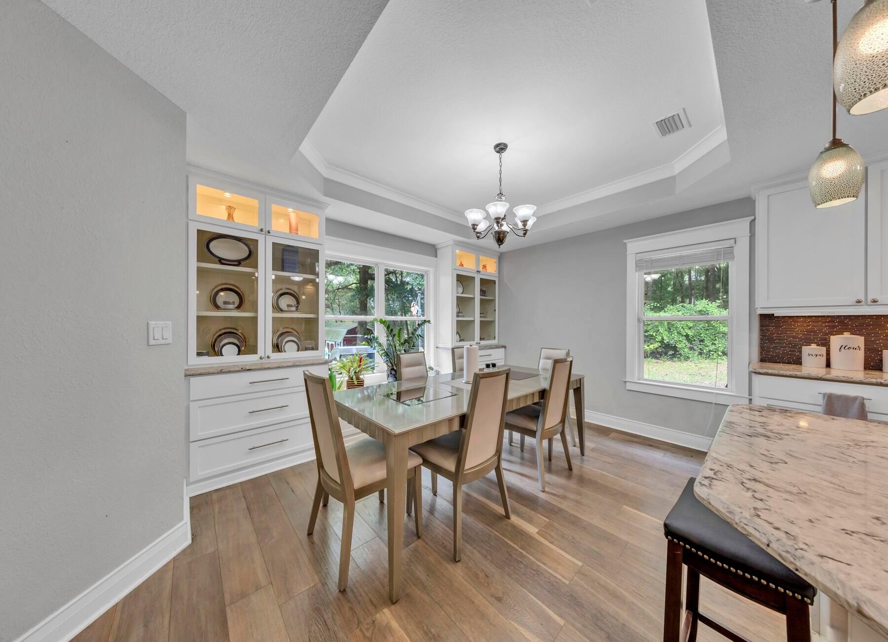 202 Shell Drive Crestview, FL 32536 - Photo 7 of 38 a view of a dining room with furniture a chandelier and wooden floor