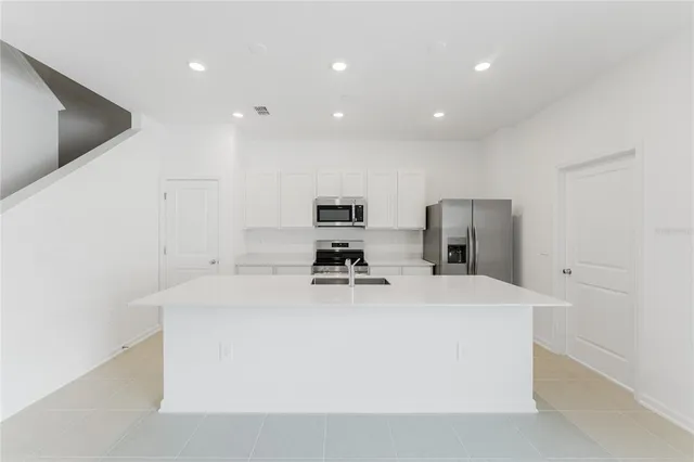 a kitchen with a refrigerator stove and microwave