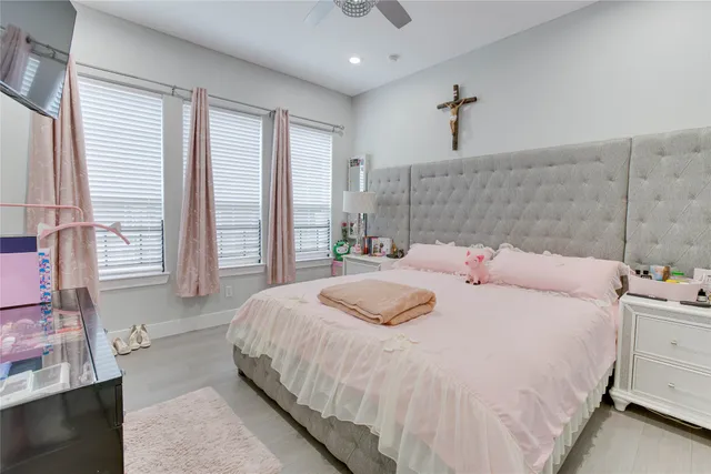 a bedroom with a large bed and a chandelier