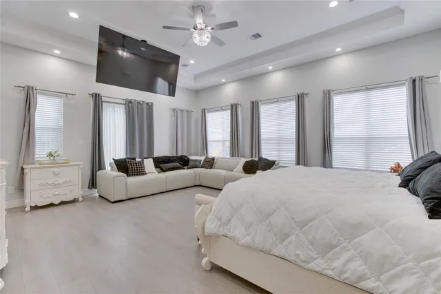 a spacious bedroom with a bed and a large window