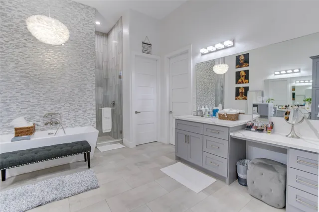 a spacious bathroom with a double vanity sink mirror and bathtub