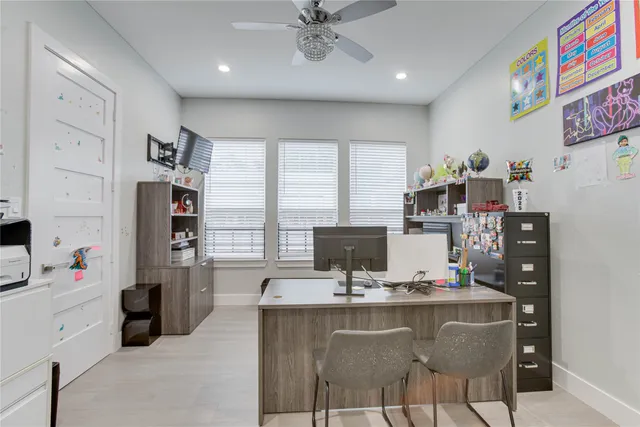 a room with furniture a flat screen tv and a refrigerator