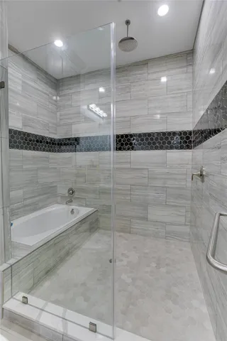 a bathroom with a shower and a tub