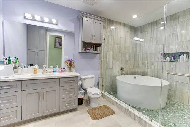 a spacious bathroom with a double vanity sink mirror and toilet