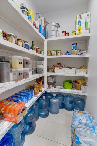 a room with stainless steel appliances lots of wooden furniture